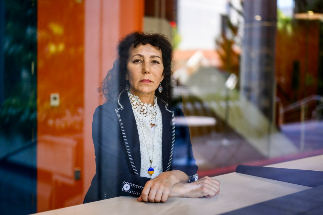 A headshot of Natalya Watson, an associate teaching professor, shown with arms crossed and a stern expression.