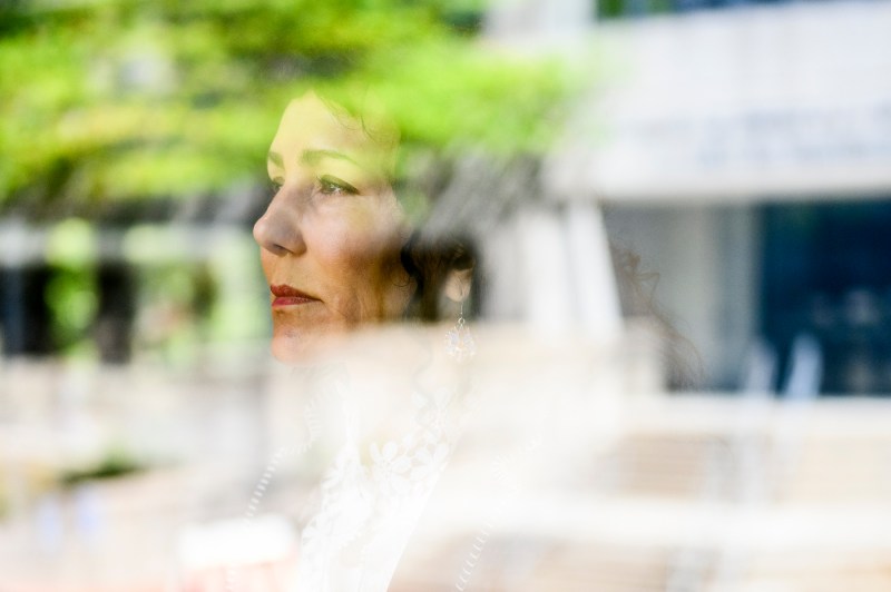 Natalya Watson looks through glass.