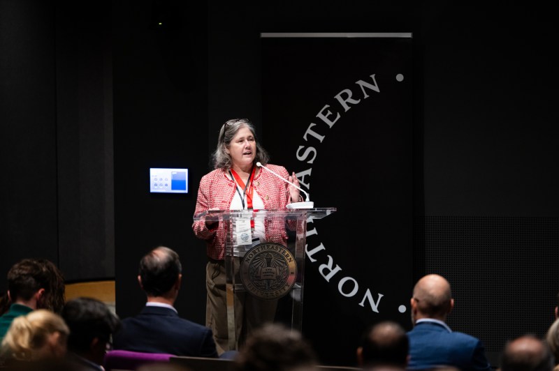 A speaker at a podium addresses the audience during Northeastern University’s Senior Leadership Retreat at the ISEC auditorium.