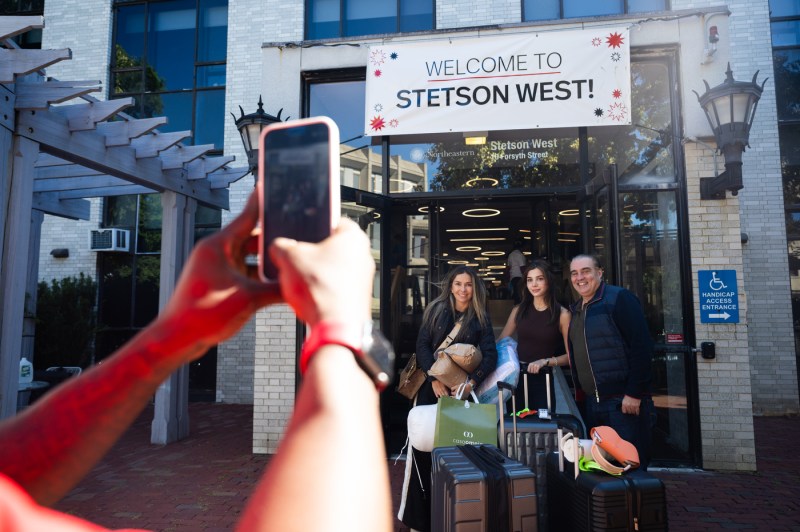 A family takes a photo outside of Stetson West.