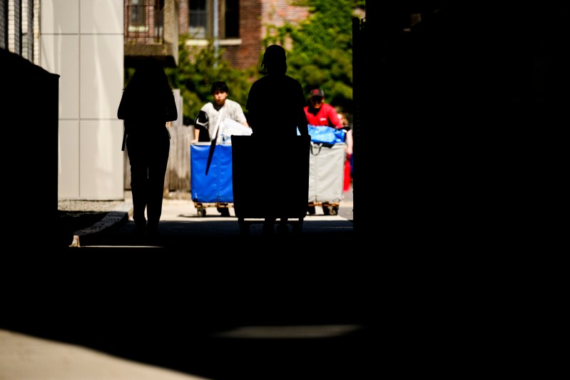 People push hampers full of move-in supplies.