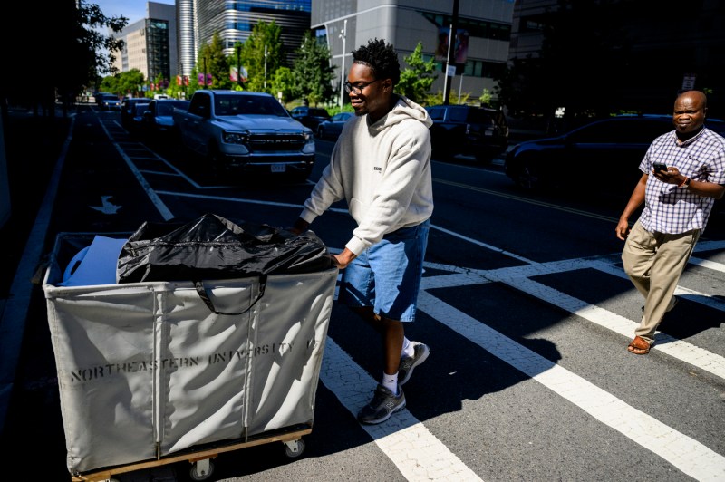 People push hampers full of move-in supplies.