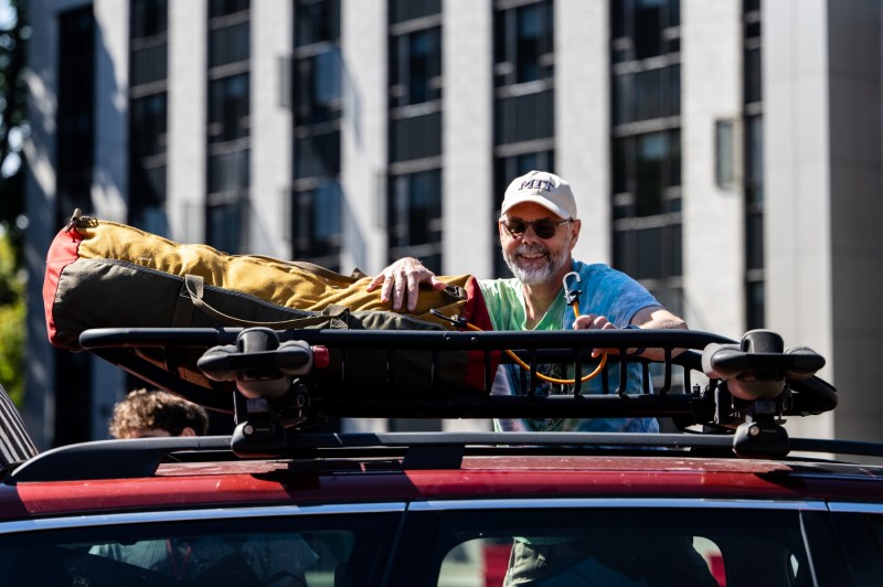A person unloads a car.