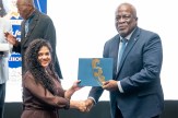 Student Abigail Persaud shown shaking hands with prime minister of Guyana, Mark Phillips.