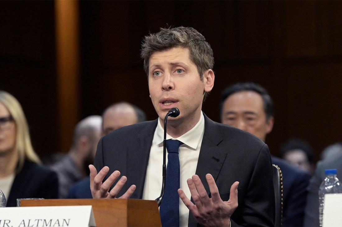CEO of OpenAI Sam Altman, featured in a suit testifying before a Senate committee.