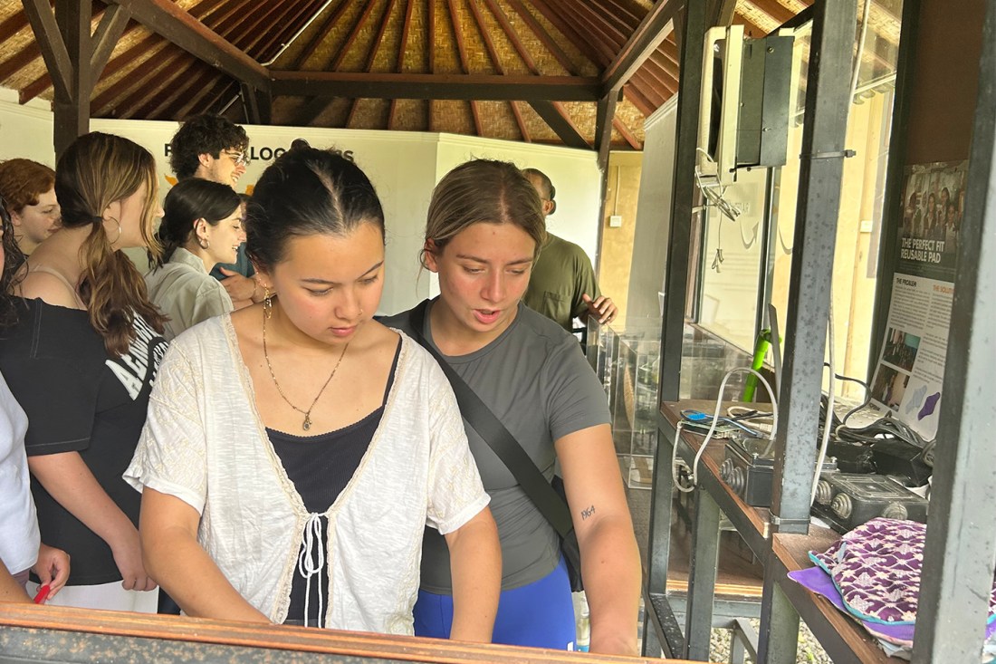 Students watching a demonstration and in the foreground some others working on a project.