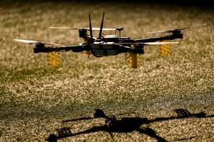 A drone flying just above a grass surface.