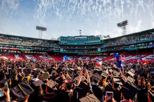 A shot of Northeastern University students celebrating graduation at Fenway Park in Boston.