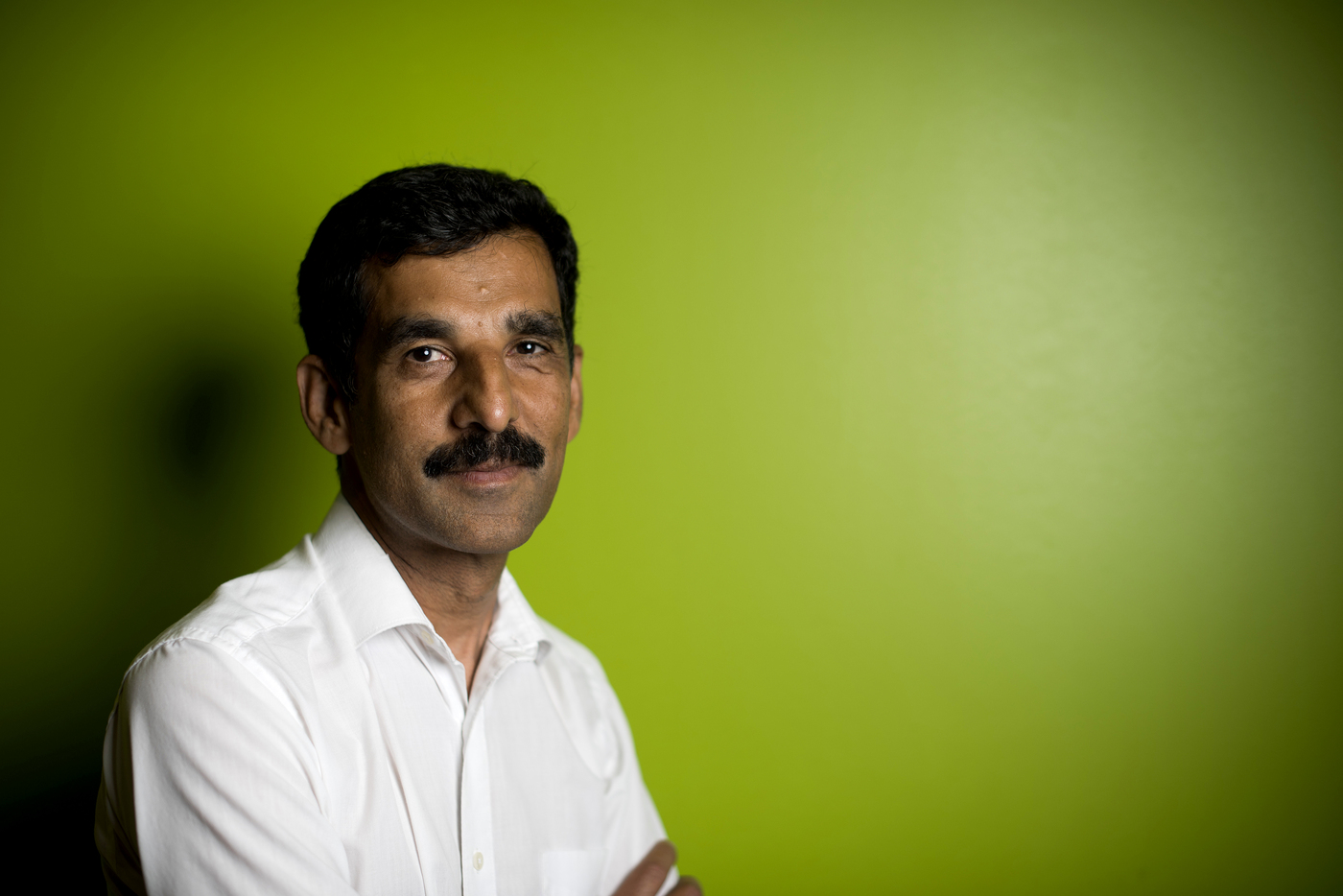 Portrait of Hanumant Singh in front of a green background.