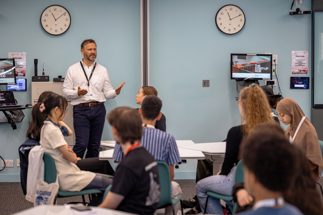 Students listen and take notes at the entrepreneurs day in London.
