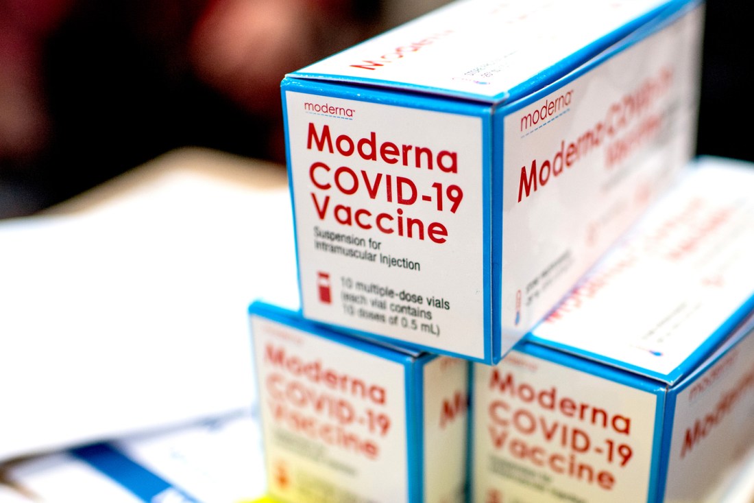 A stack of boxed Moderna COVID-19 vaccines.