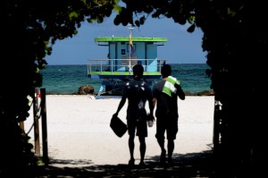 Two beachgoers pictured heading toward the sand.