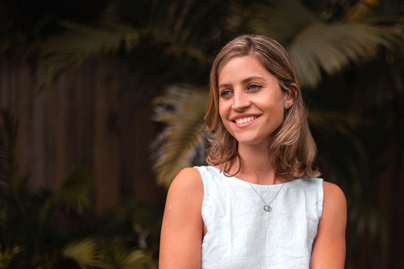 Stephanie Golik depicted smiling in a white dress.