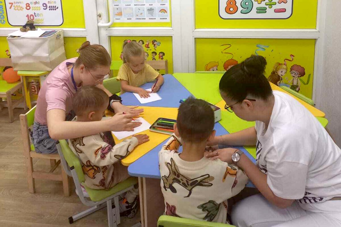 Students and teachers interacting in an underground school.