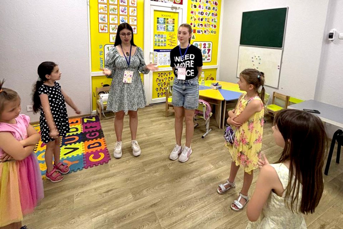 Students and teachers interacting in an underground school.