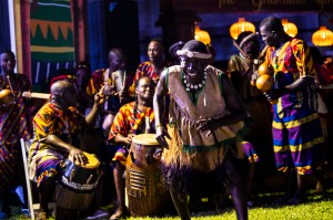 A group of people participating in traditional dancing and drumming.
