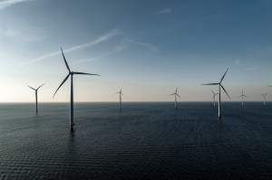 A shot of wind turbines in an offshore wind farm.