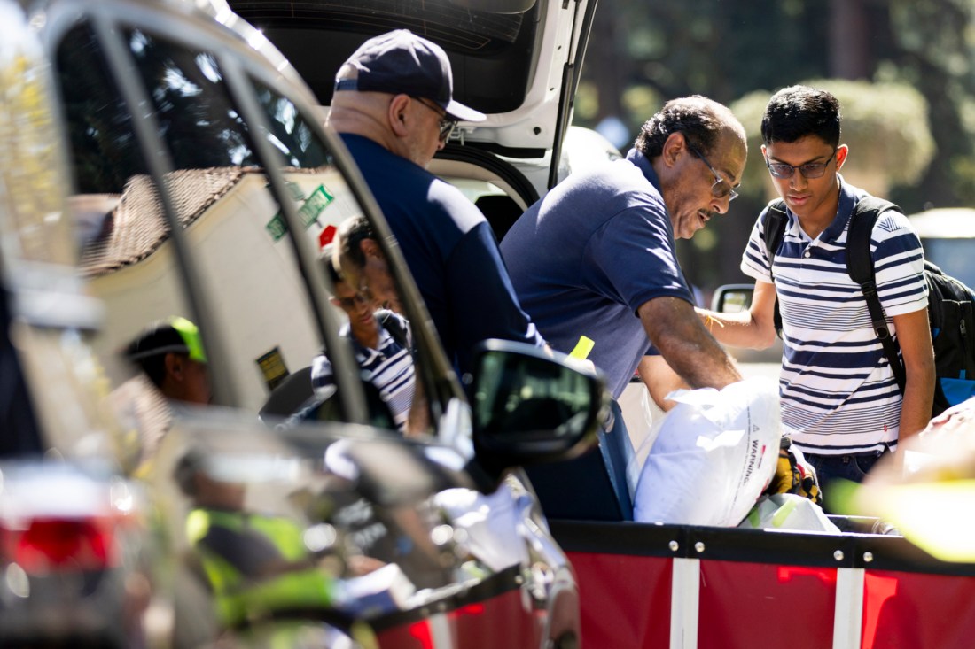 A Northeastern student checks in with staff while moving in during Fall Orientation Week on the Oakland campus.