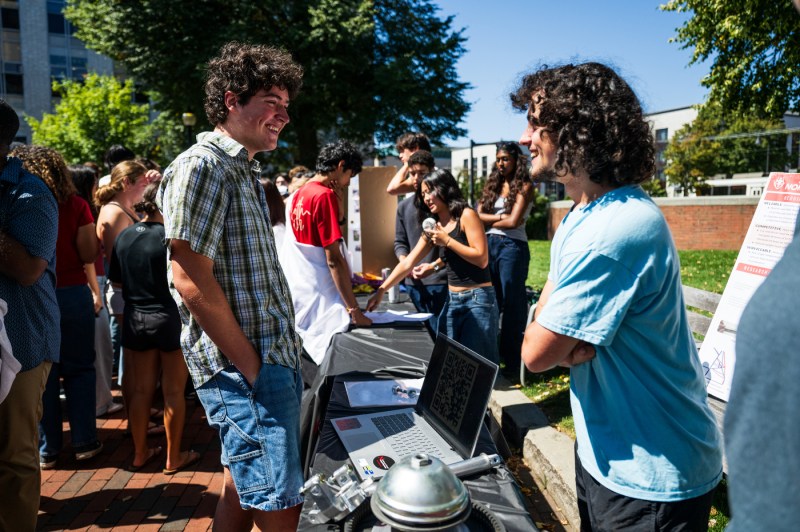 A student talks to another student at Fall Fest.