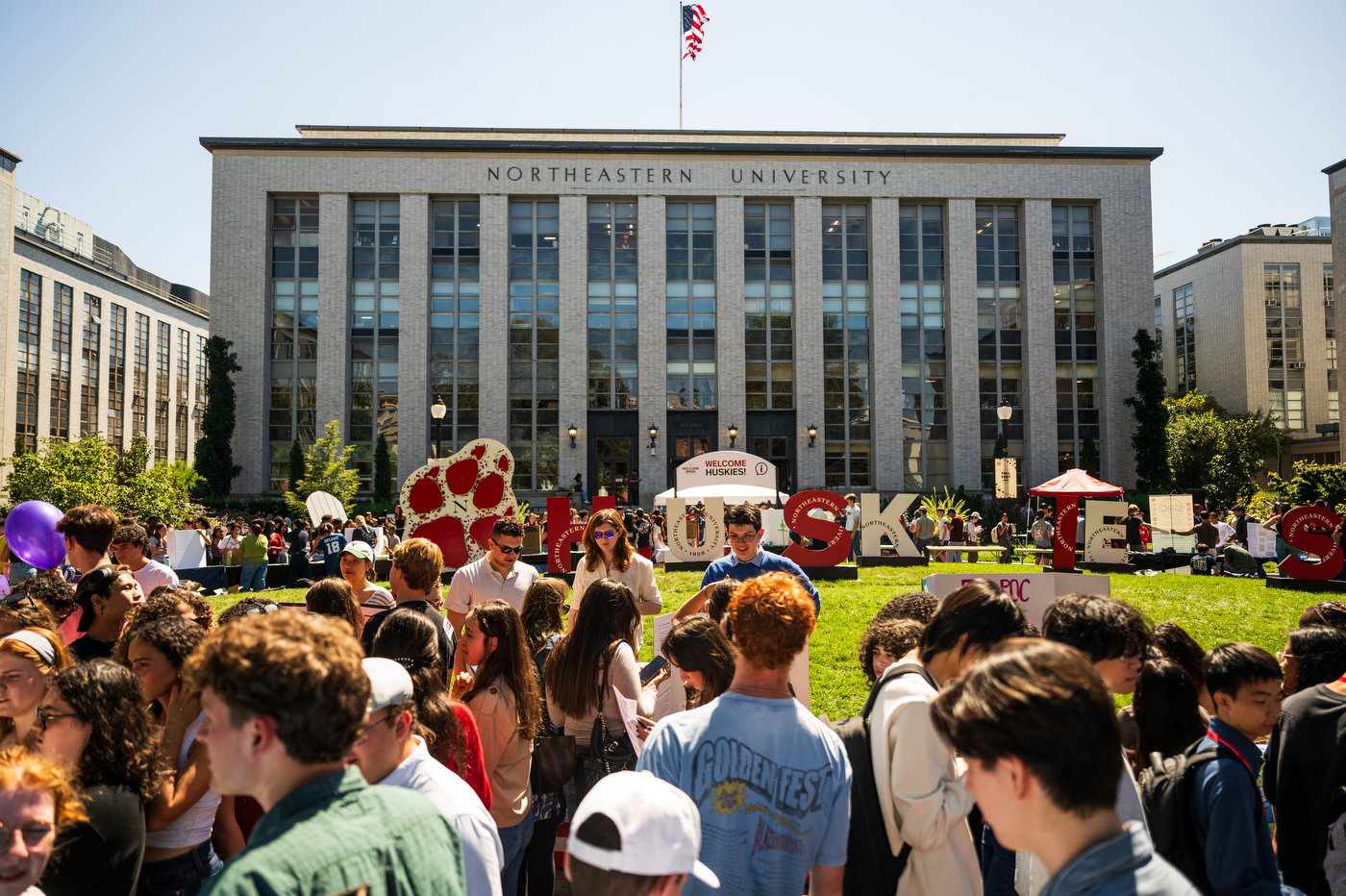 Students gather on Krentzman Quad, where there are large letters that spell out "Huskies!"