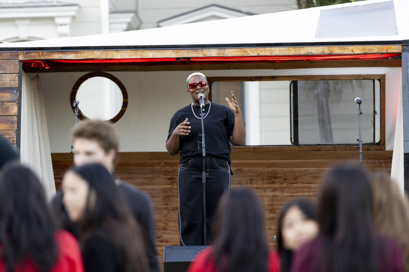 A person performs in front of a microphone at Taste of Oakland.