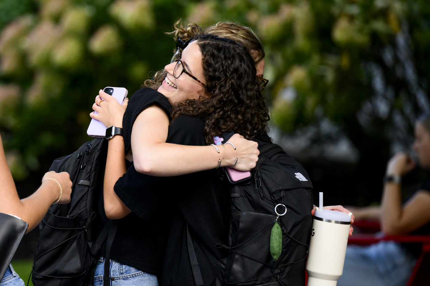 Two students hug.