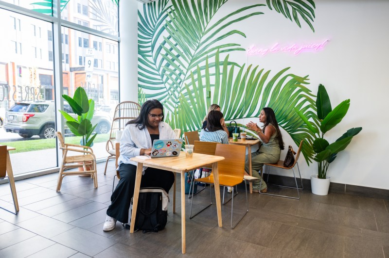 Several people sitting inside the juice bar.