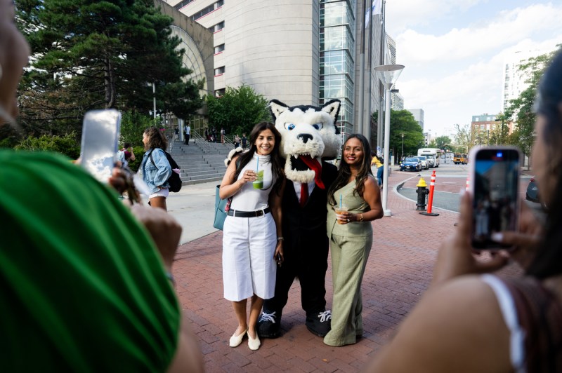 Ammy Lowney, the founder of Juicygreens, shown taking a photo with Paws, the university's mascot, and another woman.