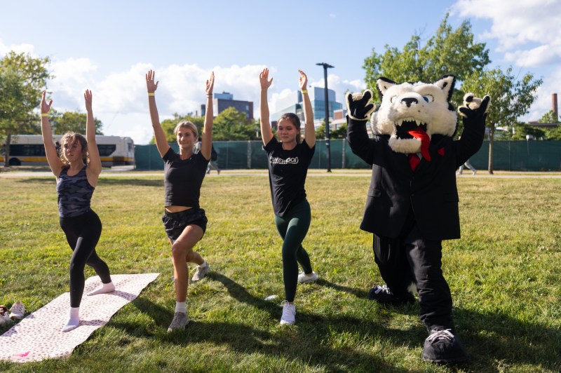 Paws joined three members of the Northeastern community in some yoga poses on the grass.