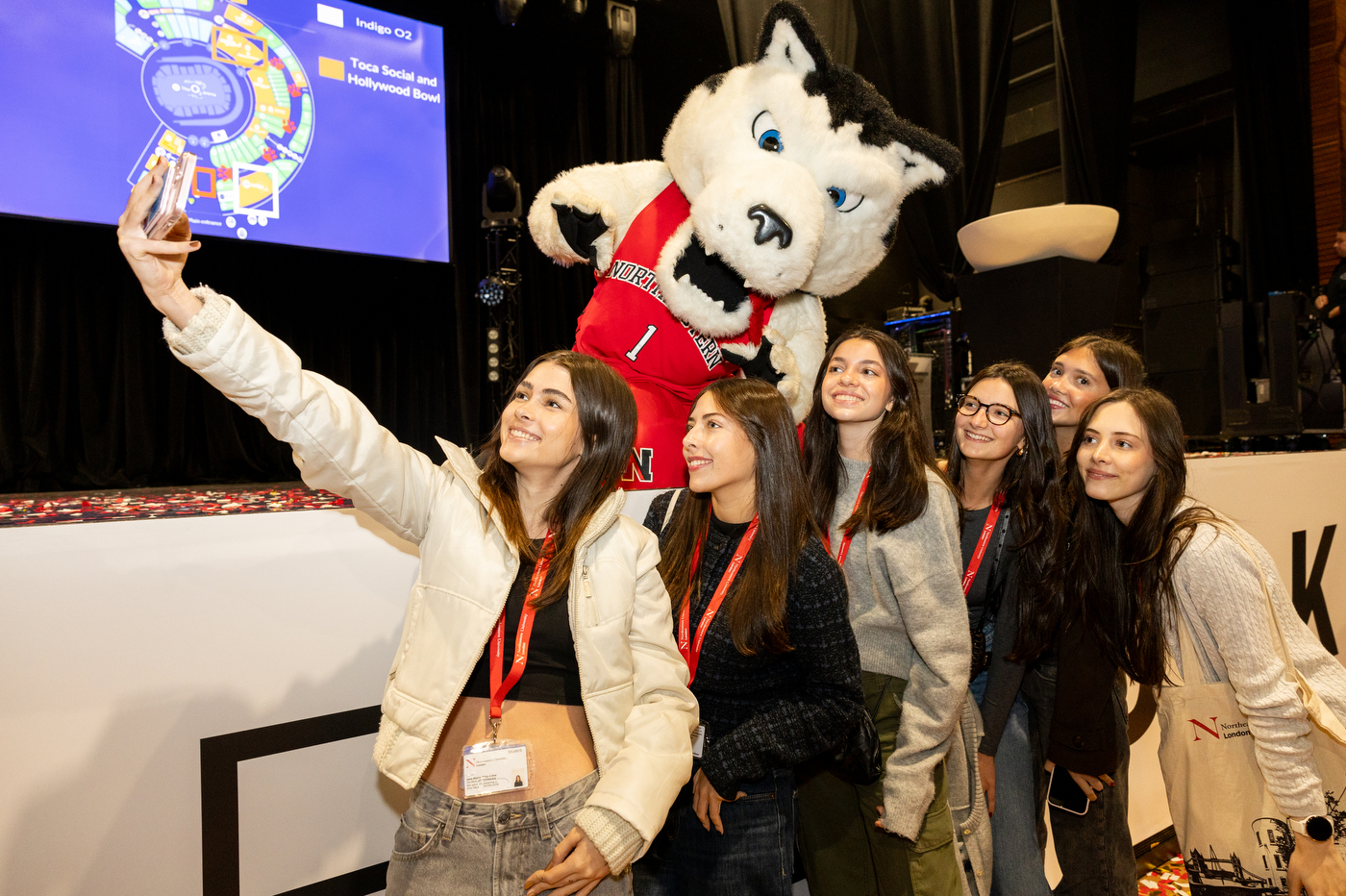 Students at the London convocation smile for a selfie with Paws.