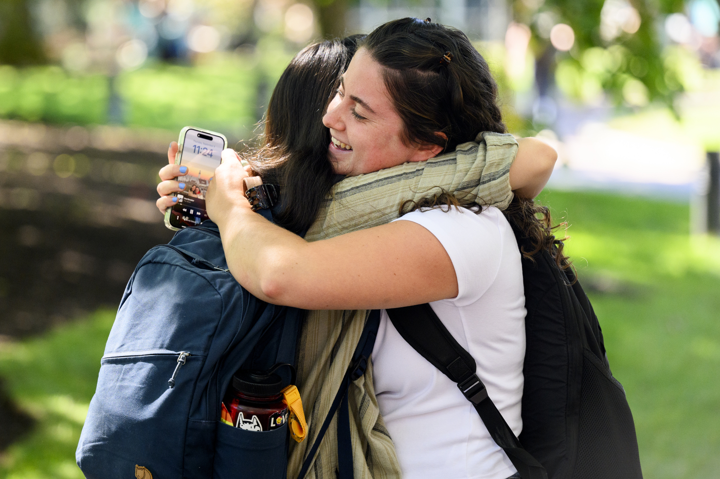 Two students hug.