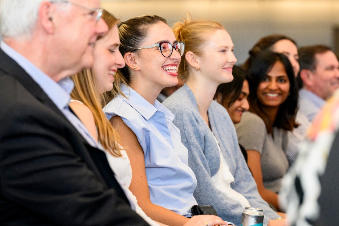 A row of audience members smiling. 