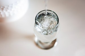 A glass of water depicted from above and against a white backdrop.