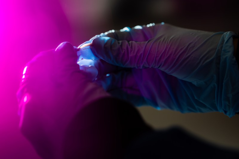 A close-up of a person's blue gloves.