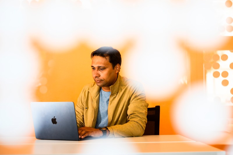 Prashant Pandey works on a laptop.