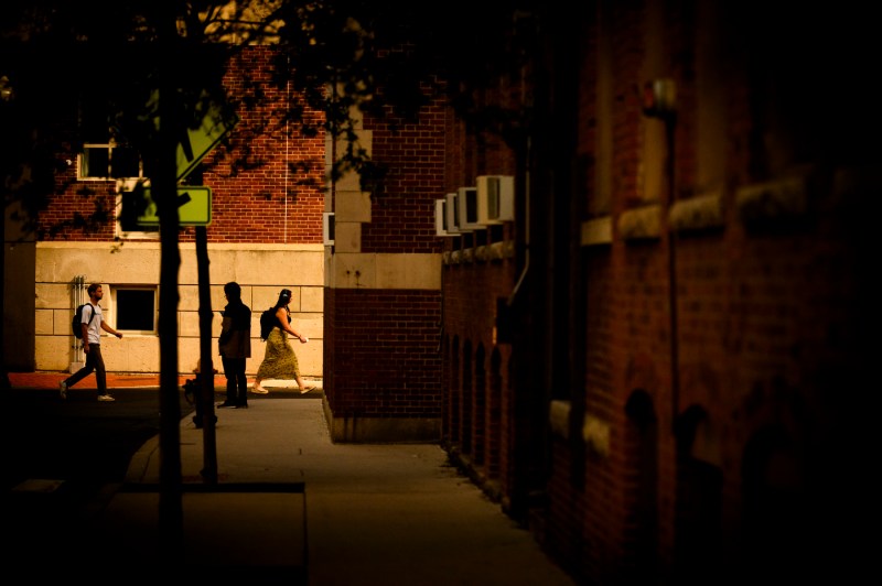 Students walk through campus during golden hour.