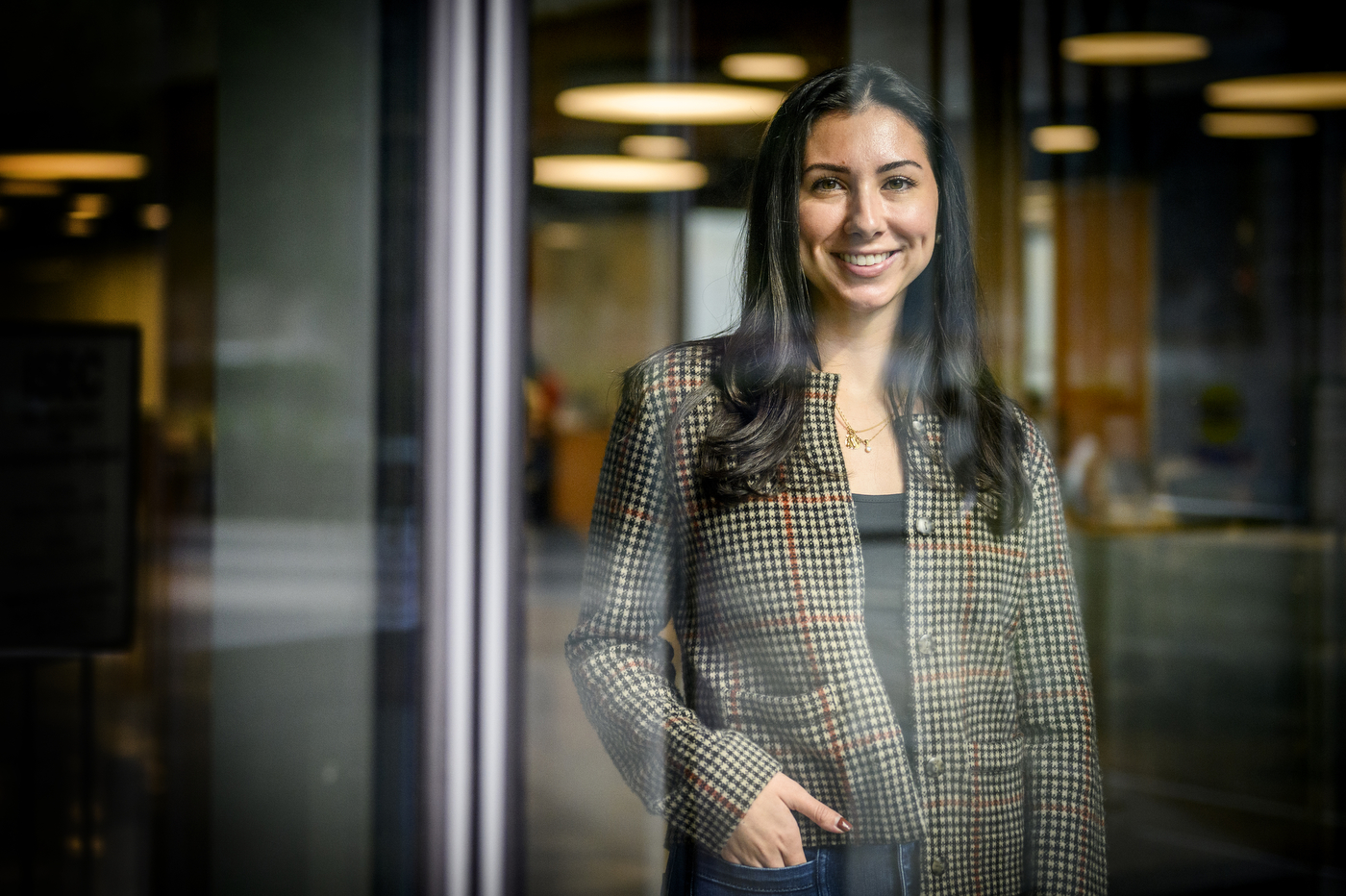 A person stands with one hand in their pocket.