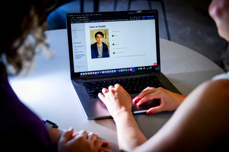 A person types on a laptop.