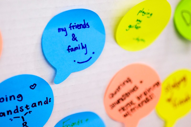 A series of different colored sticky notes on which is written positive sentiments such as "My friends & Family."