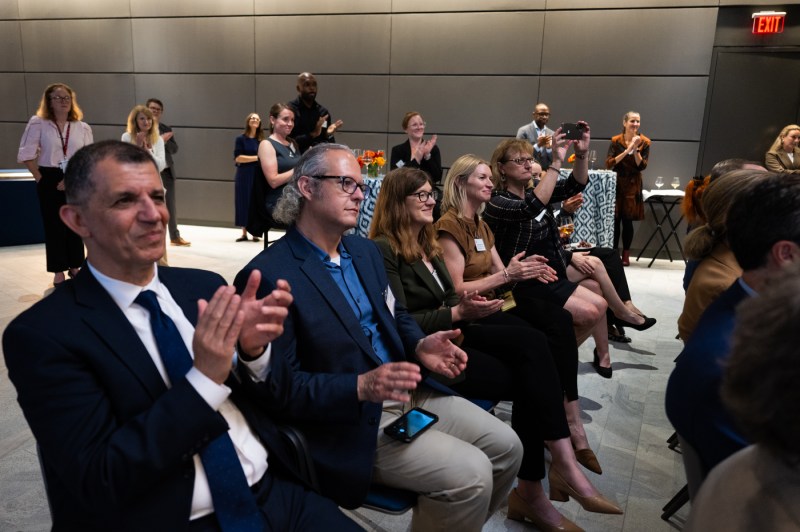 Members of the audience clap.