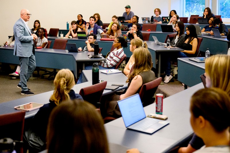 President Aoun delivers a guest lecture to students, who are seated in rows.