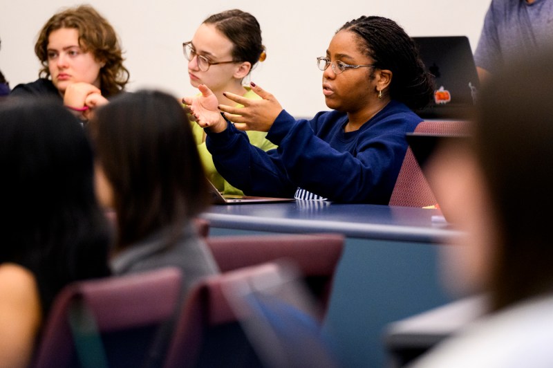 A student asks a question in a classroom.