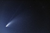 A comet shining in the night sky.