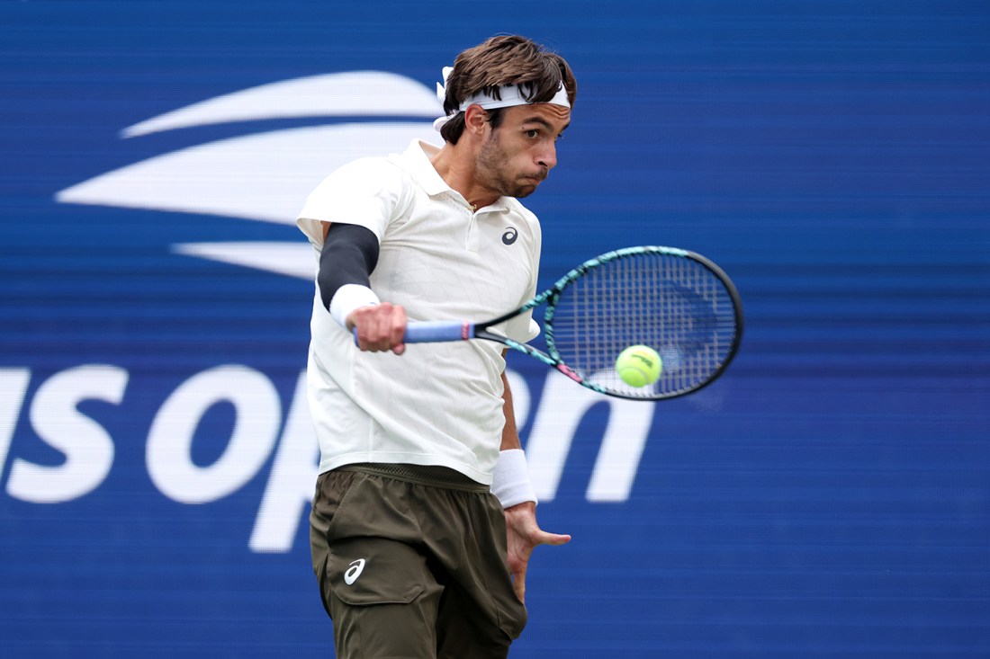 Lorenzo Musetti shown hitting a one-handed backhand at the 2025 U.S. Open.