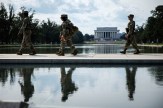 National Guardsmen depicted in front of the National Mall, walking by the Reflecting Pool.