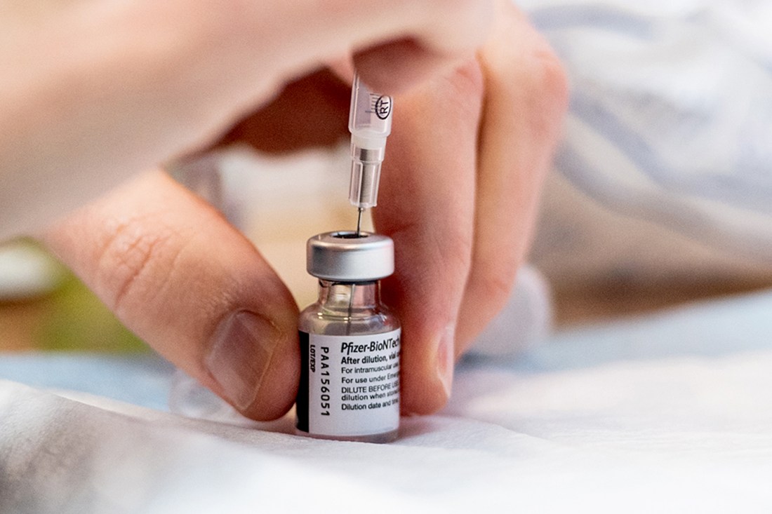 A close-up of a COVID vaccine drawn from a vial.