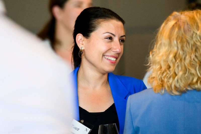 A faculty member speaks with others.