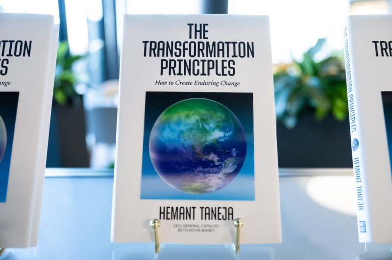 A copy of Hemant Taneja’s book The Transformation Principles: How to Create Enduring Change on display during a fireside chat at Northeastern on Oct. 6, 2025.