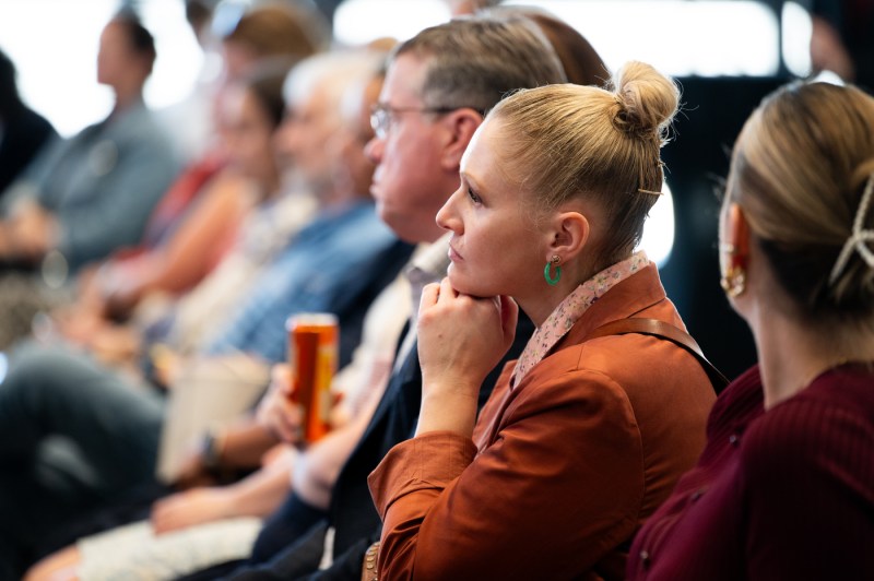 Members of the audience listen intently to President Aoun and Hemant Taneja.