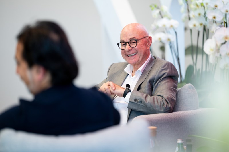 President smiles while speaking with Hemant Taneja.